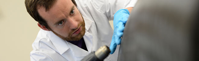 Man in white coat working in composites lab