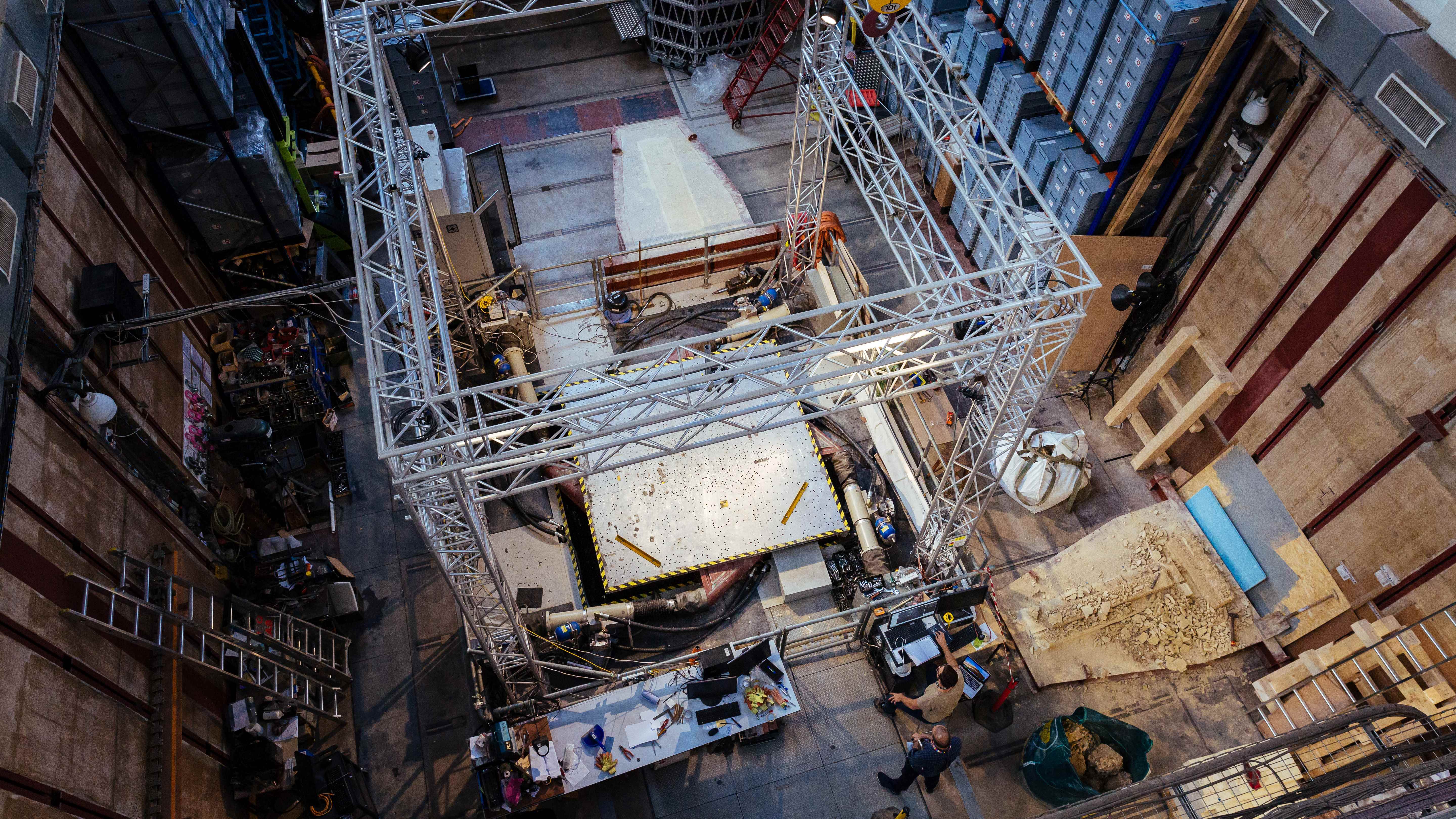 An image of an earthquake lab with academics running experiments in a warehouse
