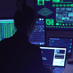 silhouette of person with multiple screens