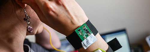 Woman with monitoring device on her wrist