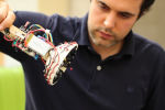 Researcher with acoustic levitation equipment