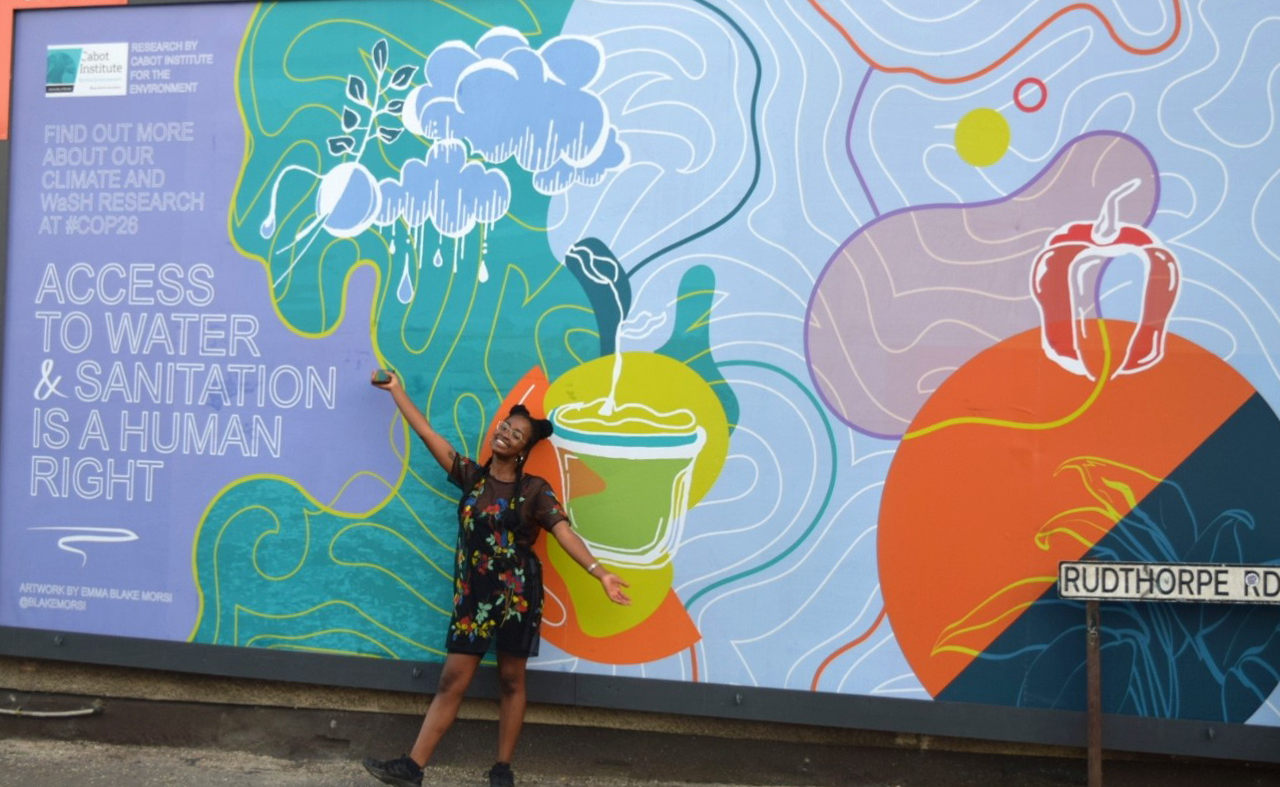 Image showing Emma Blake Morsi the artist in front of one of her billboards in Bristol entitled