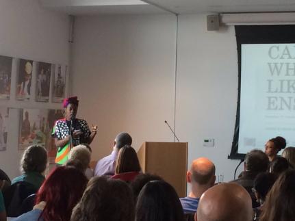 Photo of speaker addressing audience from lectern at MShed event