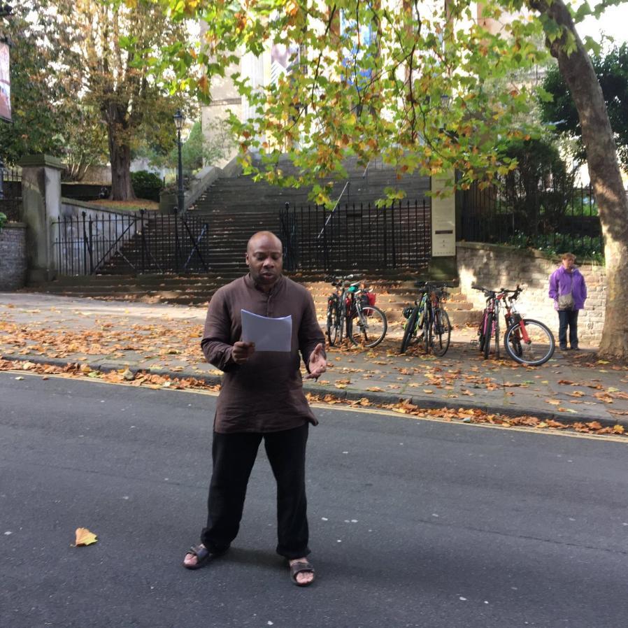 Photo of Edson Burton reading outside Georgian House