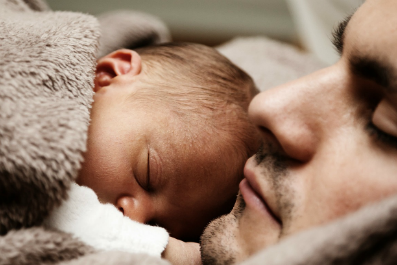 A parent holding an infant child.