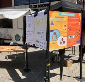 A poster board displayed outside, showing research on emotion recognition