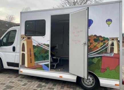 The TARG van is parked, with its side door open, inviting participants to be part of research
