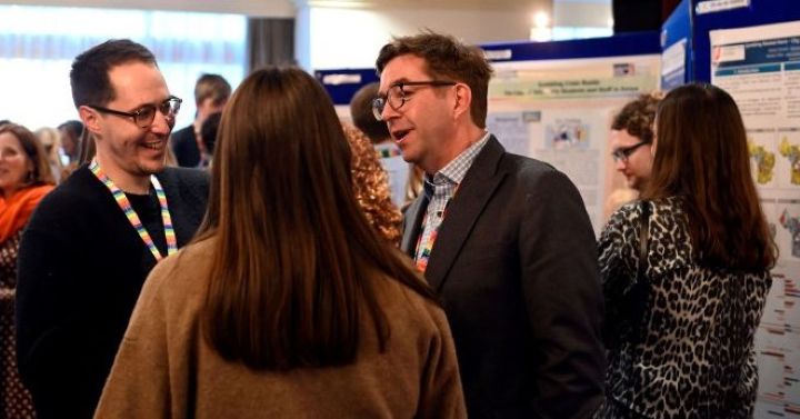 Image of 3 attendees networking at the 2024 Colloquium