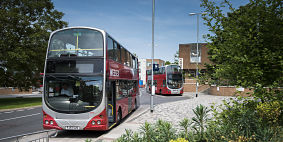 Two Wessex buses parked at a bus stop on a sunny day.