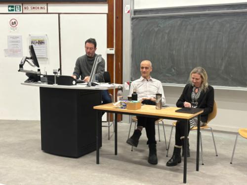 Roddy Brett, Norbert Koppensteiner and Josefina Echavarria sitting at the front of a lecture theatre.