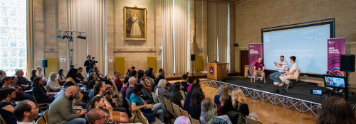 Image of people sitting in a hall listening to a lecture