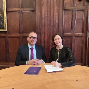 Catherine Kelly and Mohamed F. Khimji signing the MoU in Wills Building