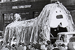 Photo of giant dog model (Dougal from the Magic Roundabout) on a lorry at a students' rag week parade.