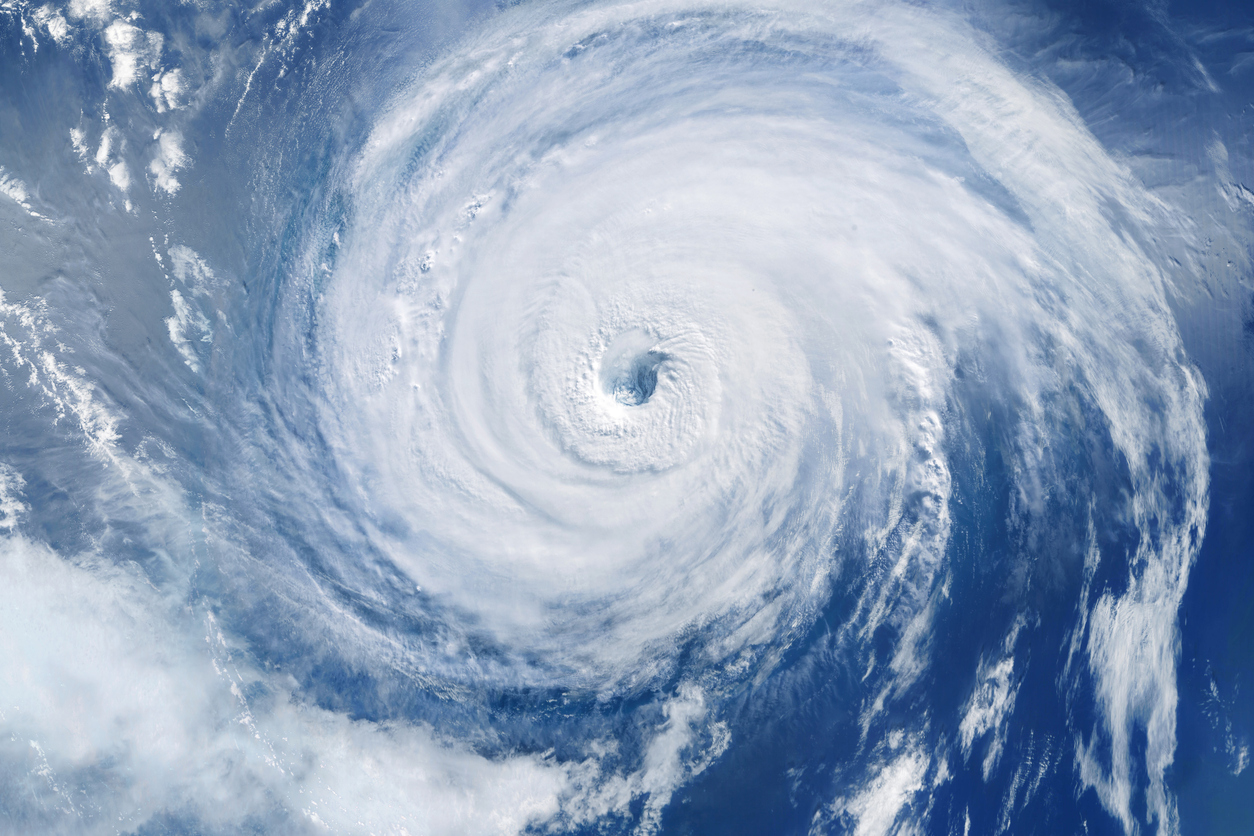 White swirling hurricane over blue water