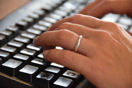 hands typing on keyboard