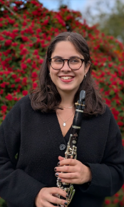 A young woman holding a clarinet