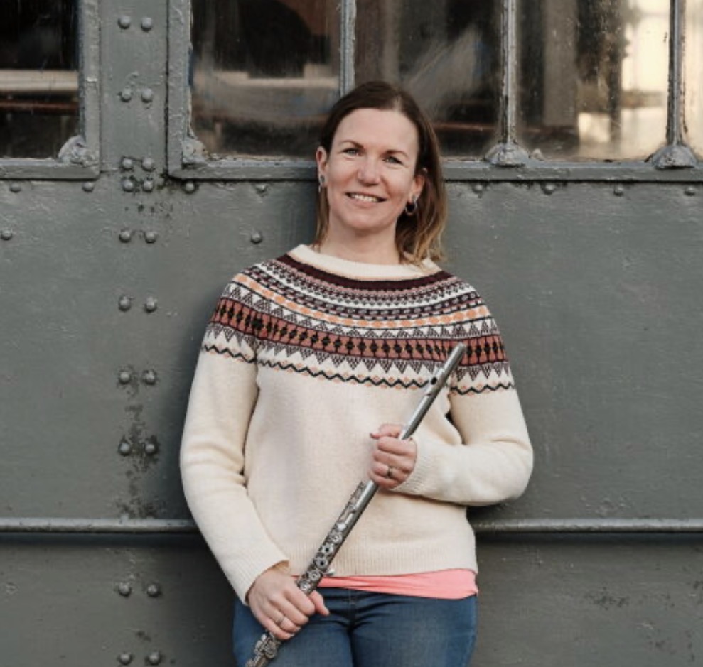 A woman holding a flute