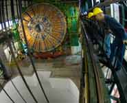 PhD students Nick Grant from Bristol University and Israel Goitom from Brunel University watch as one of the endcap sections of the CMS experiments makes the 100m descent into the experimental cavern