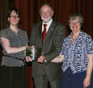 Mora McCallum (left) and Cecilia Smith receiving the Gold Award for the Faculty of Science from David Clarke