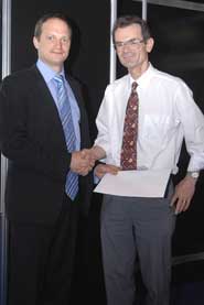 Professor Joe Quarini (right) receives his award from Piers Clark, Managing Director, Regulated Industries (Utilities, Rail & International), Mouchel