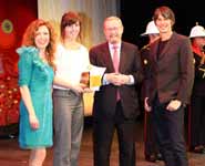 Hannah receiving her award from Kate Bellingham, Professor Brian Cox and Sir John Beddington