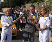 Shirley Hume passes the flame to fellow torchbearer Georgie Twigg