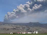 Eruption column from the explosive phase of the Eyjafjallajokull eruption drifting over a farm 10km to the south of the volcano, Iceland, 8 May 2010