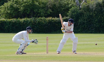 Cricket player striking ball