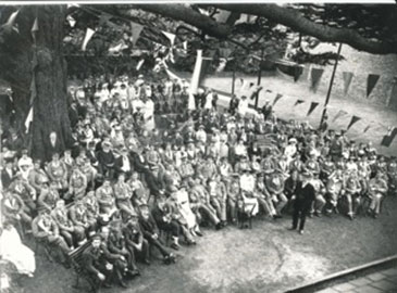 Convalescing soldiers at Enfield Palace in 1916 attending an entertainment event organised by the Enfield Constitutional Club.  
