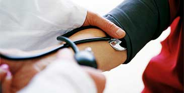 Doctor using a sphygmomanometer to test a patient's blood pressure