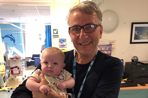 Professor Massimo Caputo holding Finley on day he left hospital