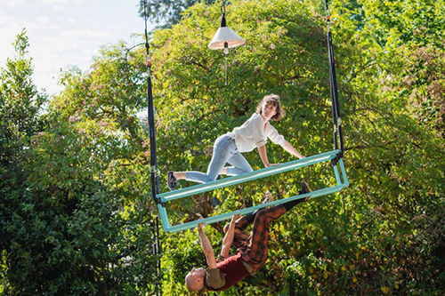 A woman and man in an aerial luggage rack