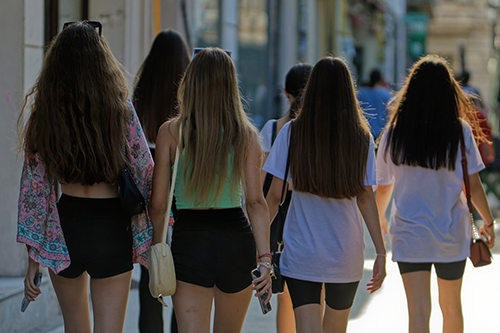 Teenagers walking along a road