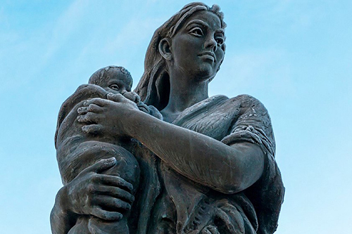 National Child Mortality Database (NCMD) Programme Thematic Report's cover image that shows a stone sculpture of a woman holding a child