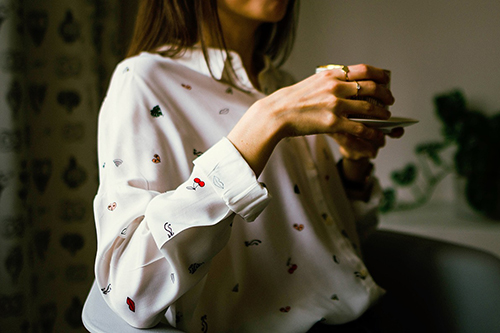 A woman holding a mug of coffee