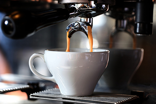 Coffee pouring into a mug from a machine