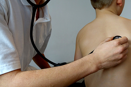 A young boy undergoing a respiratory examination