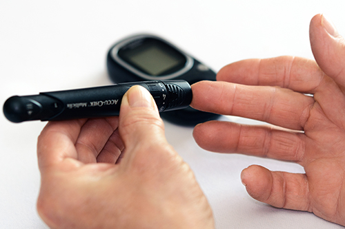 A person checking their blood glucose level