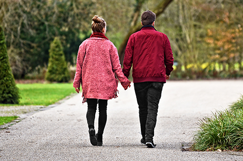 Back view of a couple walking in a park