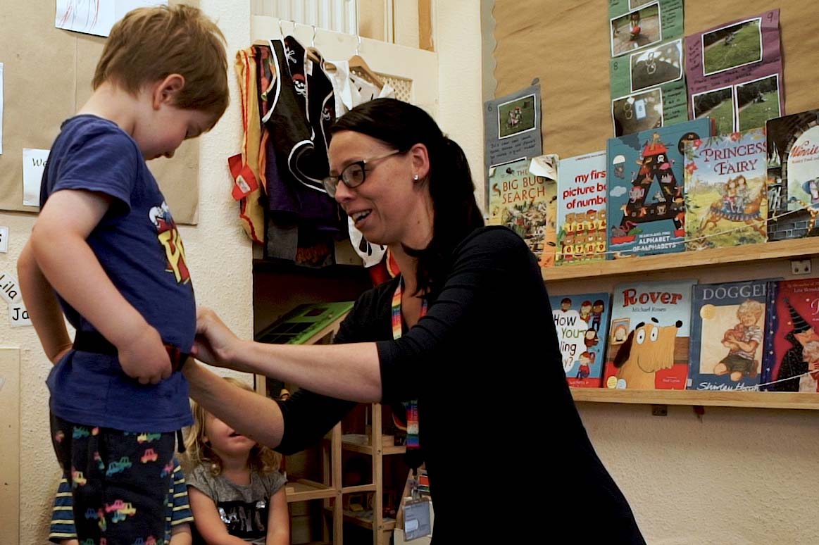 A preschool boy having his waist measured