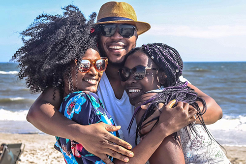 Family members hugging on the beach