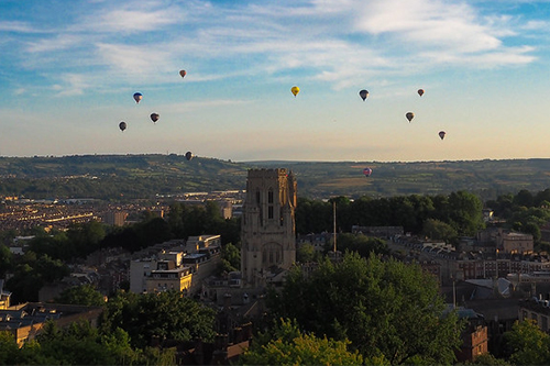 Air balloons flying in the sunny skies about the Wills Memorial Building