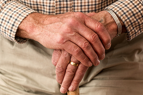 A stock image of an elderly man holding a walking stick