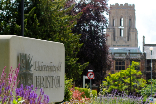 University of Bristol sign with Wills Memorial Building in the background