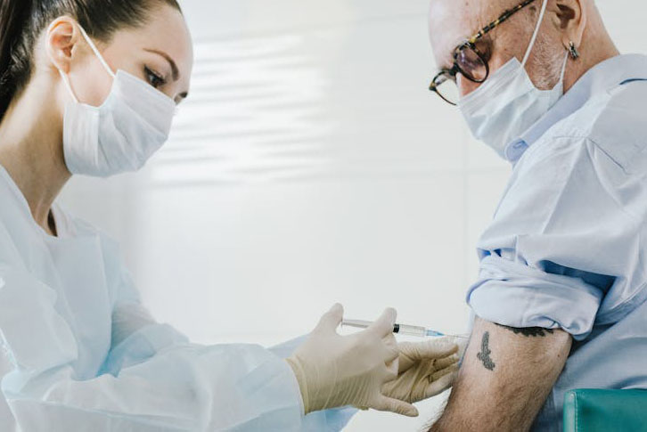 An older man receiving a vaccination