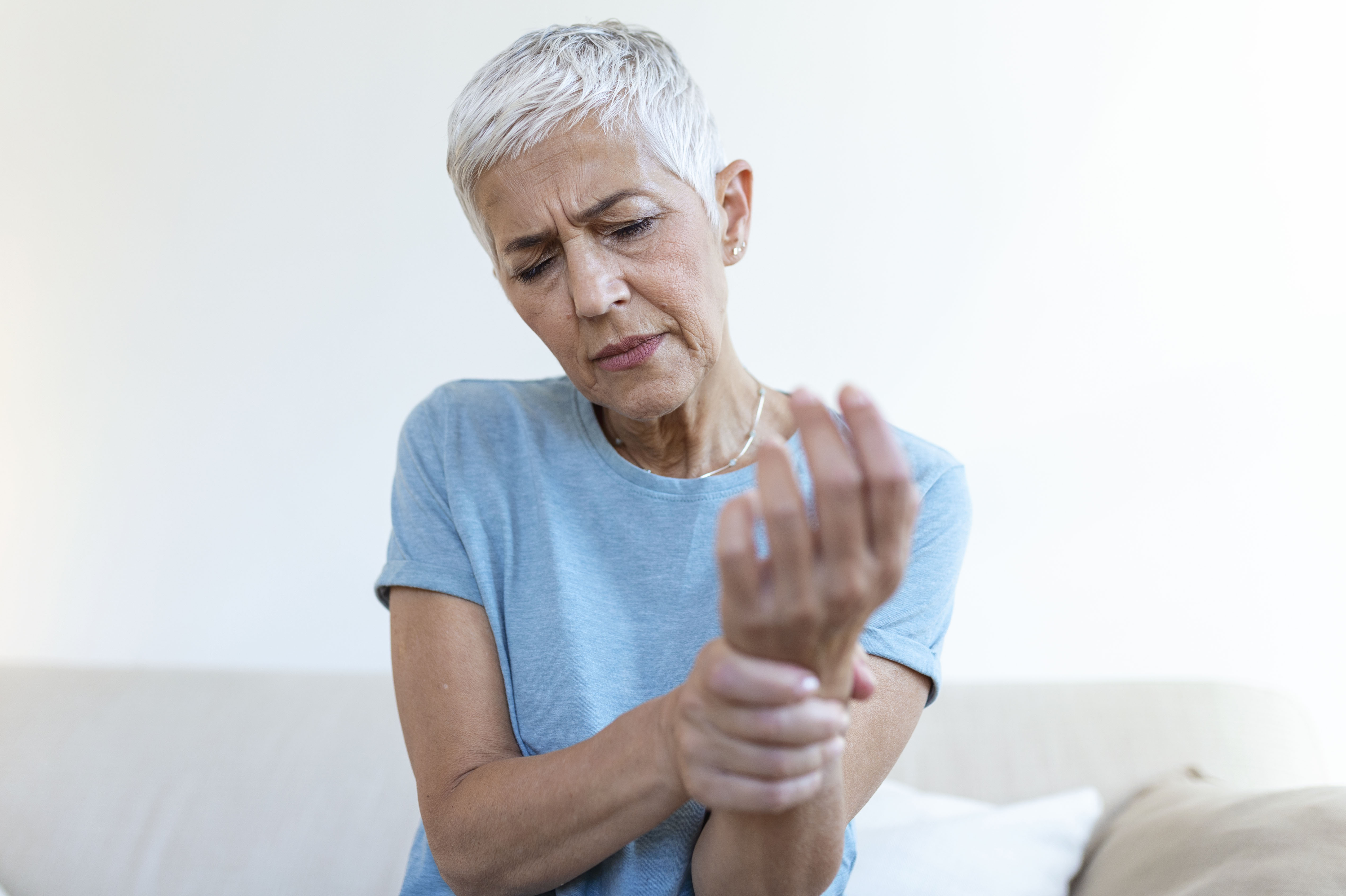 A woman suffering with hand pain