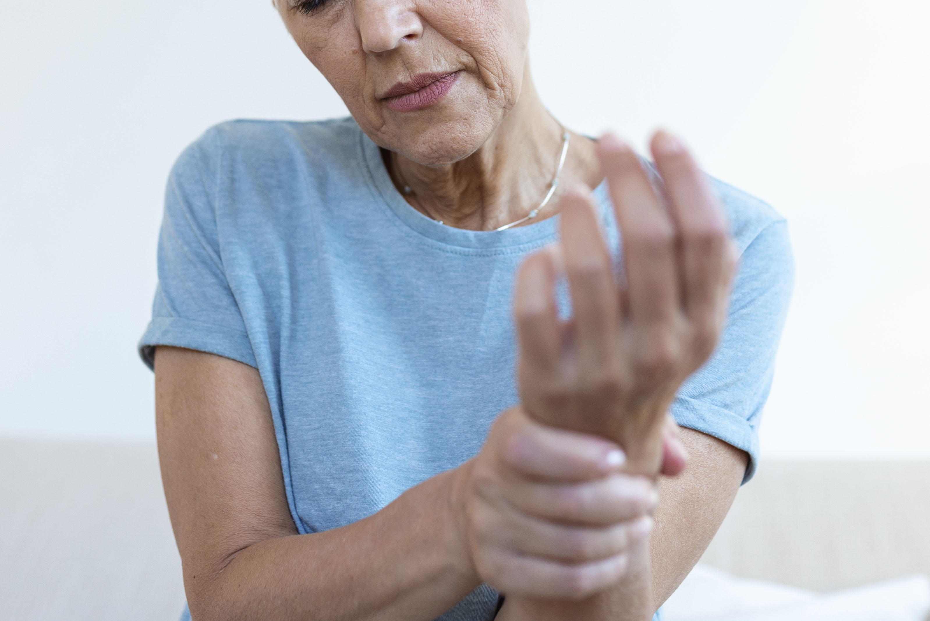 A woman suffering with hand pain