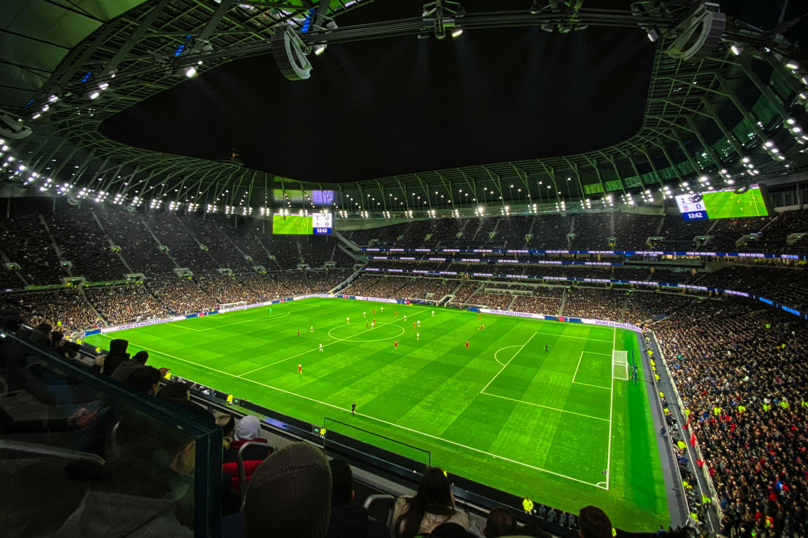 An evening football match at a packed stadium in England