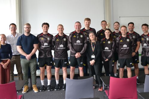 Group photo of University of Bristol staff with staff from Bristol City Football Club