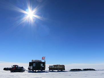 A pisten bully towing the caboose, equipment and fuel from one campsite to another; image by Damon Davies.
 
